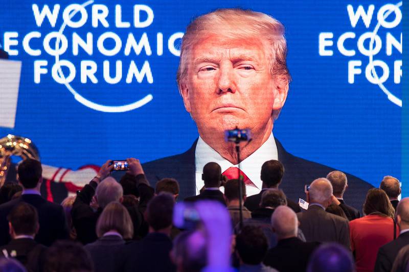 Participants watch the appearance of US President Donald Trump on screen from an adjacent room, during the 48th Annual Meeting of the World Economic Forum (WEF) in Davos, Switzerland. Gian Ehrenzeller / EPA