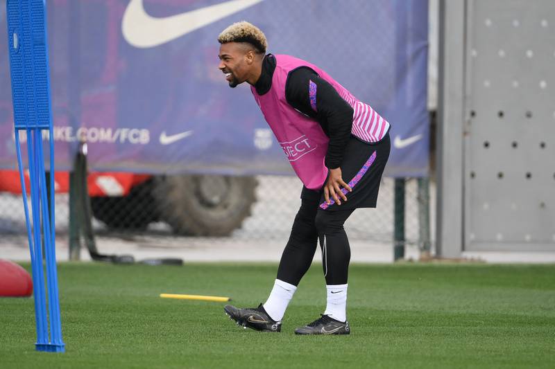 Barcelona attacker Adama Traore stretches during training. AFP