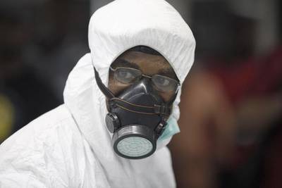 A Nigerian port health official wears protective gear at the arrivals hall of Murtala Muhammed International Airport in Lagos. Sunday Alamba / AP Photo