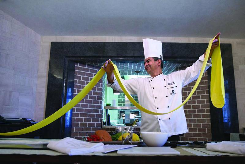 Stefano Viola, the head Italian chef at the Villa Toscana restaurant at the St Regis Abu Dhabi on the Corniche, demonstrates pasta preparation, which he teaches during his regular cooking classes at the hotel. Silvia Razgova / The National

