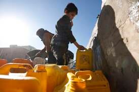 Yemenis fill jerrycans with water from a donated tank amid a severe water shortage on the roadside on the outskirts of Sana'a, Yemen. EPA