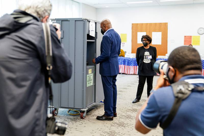 US Senator Raphael Warnock casts his ballot in the state's general primary at a Fulton County polling station in Atlanta, Georgia. Reuters