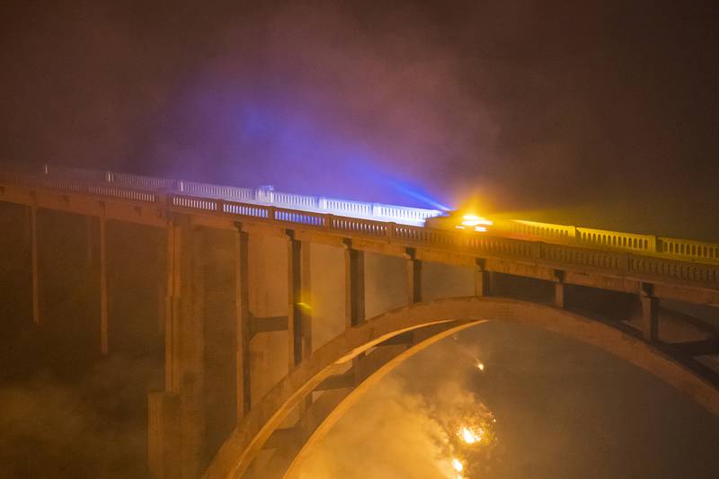 The Colorado Fire illuminates Rocky Creek Bridge on Highway 1 as it burns below.