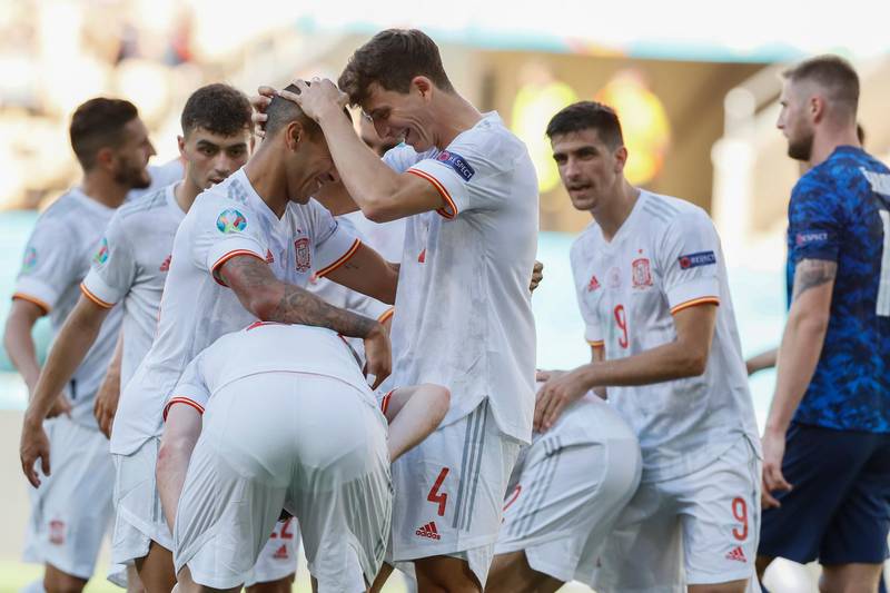 Spain players celebrate after Slovakia's Juraj Kucka scored an own. AP