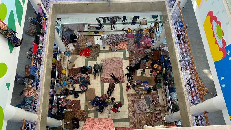 Displaced Palestinians who fled their houses after Israeli strikes take shelter at Rantisi hospital in Gaza city. Reuters 