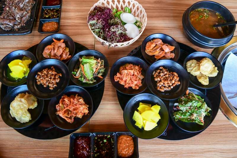 Side dishes served with the barbecue include kimchi, soy peanuts and various salads 