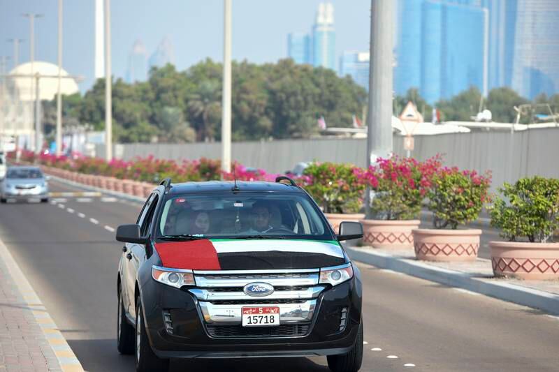 A car decorated with a UAE flag at Abu Dhabi Corniche. Khushnum Bhandari / The National
