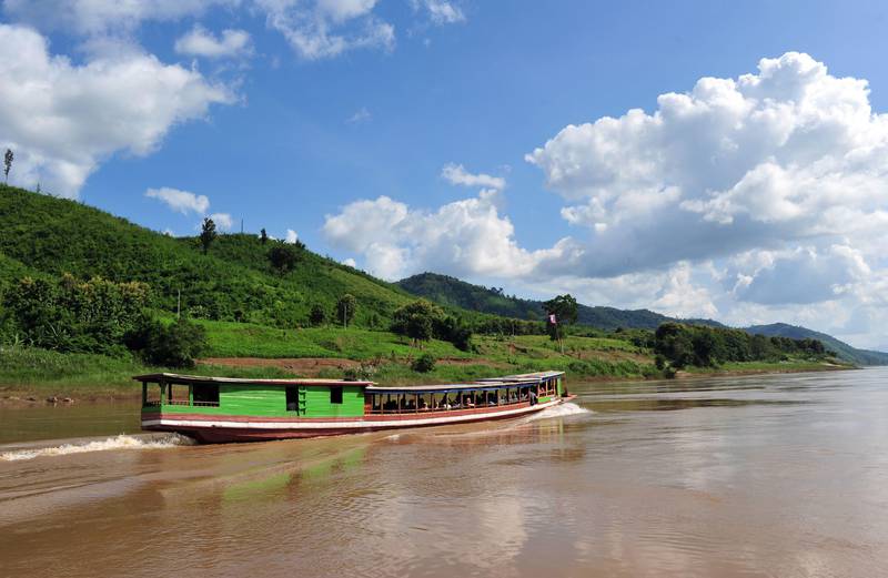 A "slow" boat cruises on the Mekong river on October, 15 2009 near the Thai-Lao border town of Huay Xay in northern Laos. Trips on slow boats from the Thai-Lao border town of Huay Xay to Luang Prabang take two days on a slow boat when they can be reduced to six hours on the "fast" boats but are a much cheaper and safer solution for travellers. AFP PHOTO/VOISHMEL *** Local Caption ***  082163-01-08.jpg