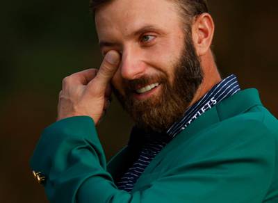 Dustin Johnson celebrates with his green jacket. Reuters