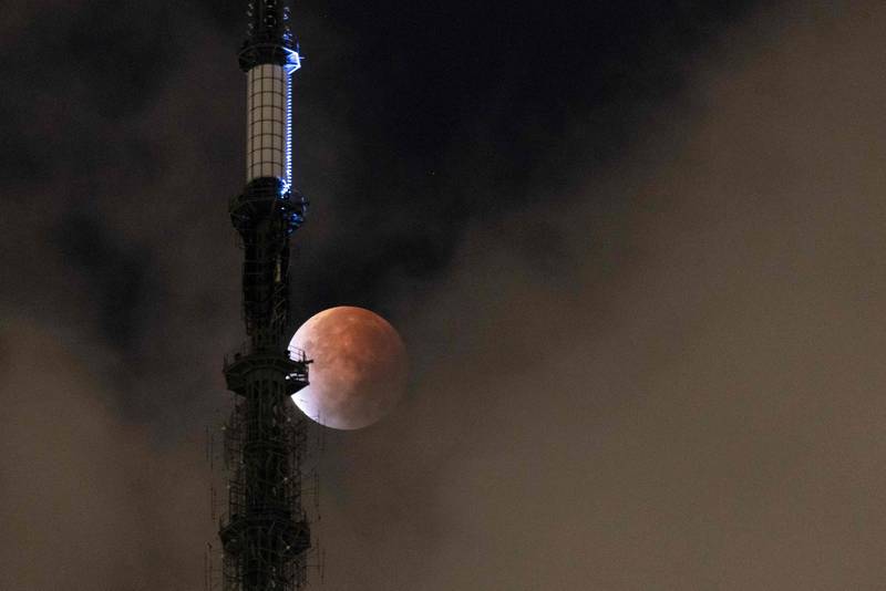 The Moon during a lunar eclipse behind the One World Trade Centre in New York early on November 19, 2021. AFP