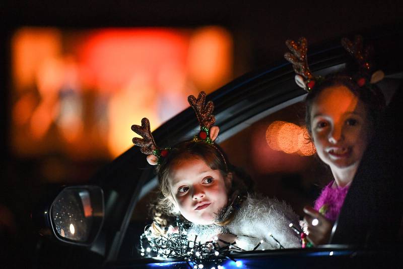 Children look out of a car window of a drive-in movie on December 10, in Perth, Scotland. Getty