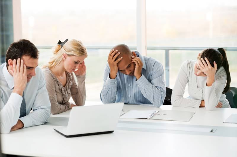 Serious group of businesspeople having problems at work. (iStockphoto.com)