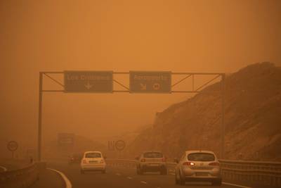 Cars drive on the TF-1 highway during a sandstorm in Santa Cruz de Tenerife.  AFP