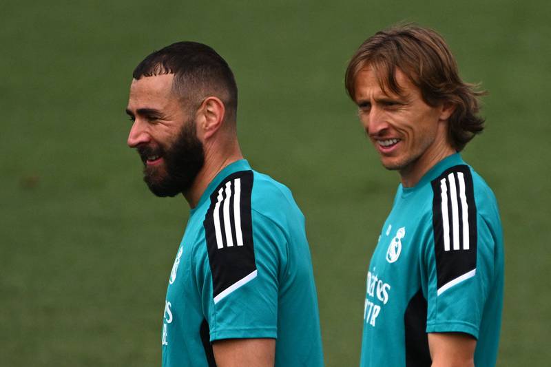 Real Madrid's Karim Benzema, left, and Luka Modric share a joke at training for the Champions League final. AFP