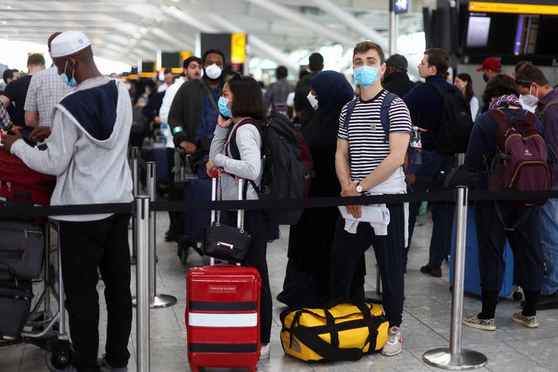 Passengers wait for check-in at Heathrow Airport in London. Reuters