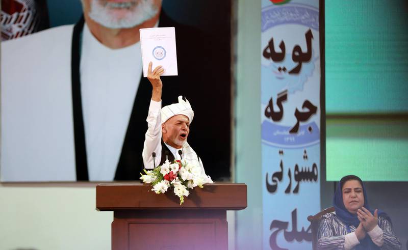 Afghan President Ashraf Ghani holds up the final draft of the loya jirga's resolution. EPA