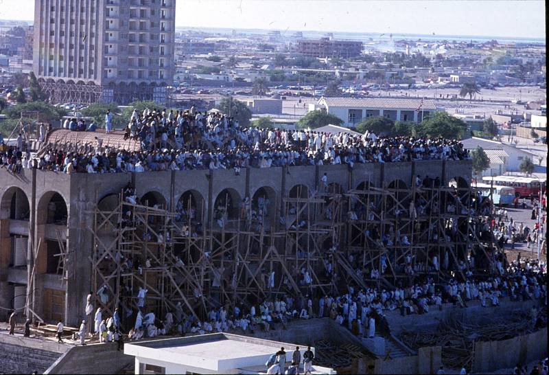 Crowds gather on a building under construction to watch the UAE's second National Day parade go by in Abu Dhabi, in 1973. Photo: Peter Alves