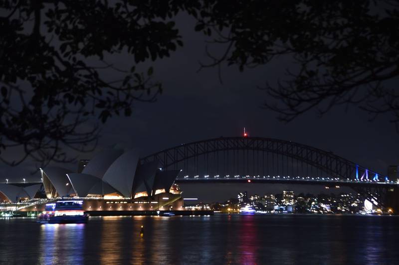 Sydney Harbour Bridge and the Opera House are plunged into darkness for the Earth Hour. Peter Parks / AFP