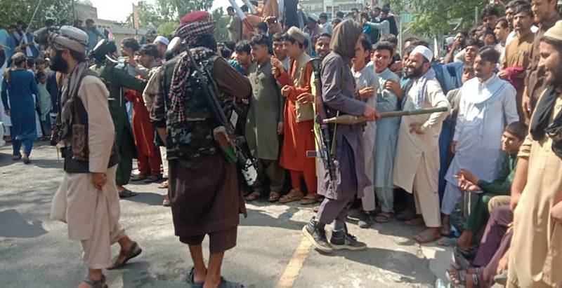 Taliban fighters and local people gather in Jalalabad province, east of Kabul.