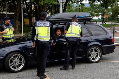 Spanish police officers control traffic on the Spain-France border in Irun. Reuters