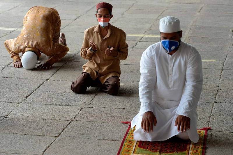 Muslim devotees offer prayers while maintaining social distancing as the historic Makkah Masjid reopens after a lockdown imposed as a preventive measure against the spread of the coronavirus, in the old city of Hyderabad.  AFP