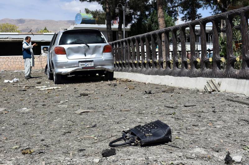A man takes pictures at the site of a car-bomb explosion at an intelligence compound in Aybak, the capital of the Samangan province in northern Afghanistan. AP