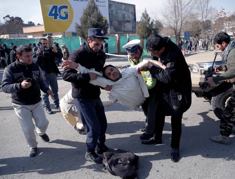 People carry an injured man a blast in Kabul. Mohammad Ismail / Reuters