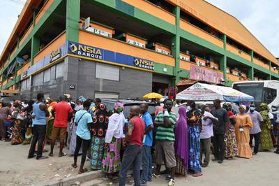 People queue to receive Pfizer Covid-19 vaccine doses at the Ajame main market in Abidjan. AFP