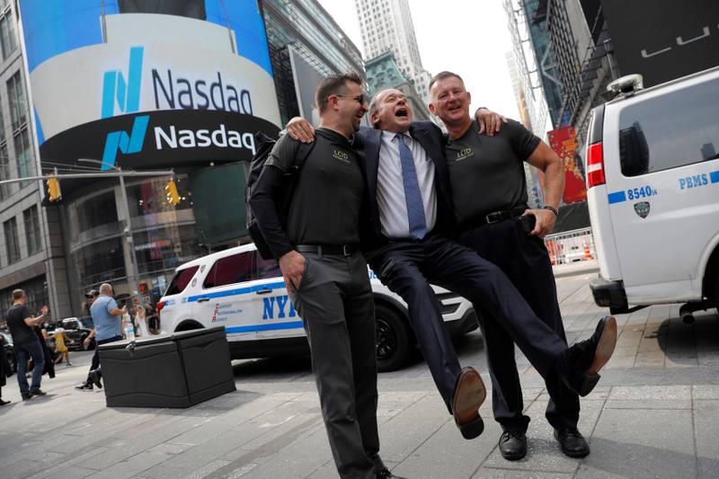 Lucid Motors' chief executive Peter Rawlinson takes photos with colleagues outside the Nasdaq MarketSite as the company begins trading on the Nasdaq stock exchange on Monday. Andrew Kelly / Reuters