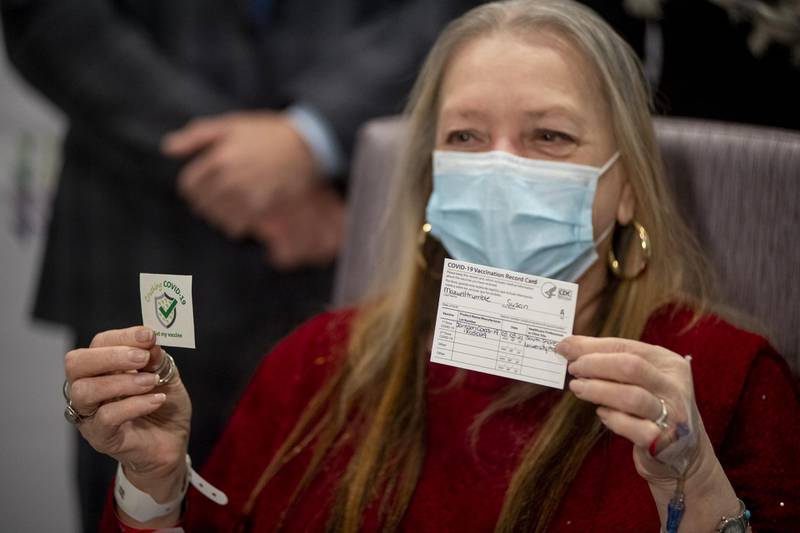 Susan Maxwell-Trumble, a 67-year-old from Babylon, holds up a vaccination card after receiving a dose of the Johnson & Johnson Covid-19 vaccine at Northwell Health South Shore University Hospital in Bay Shore, New York, U.S., on Wednesday, March 3, 2021. President Biden said that Merck & Co. will help make Johnson & Johnson's single-shot coronavirus vaccine, a collaboration between rivals aimed at ramping up the pace of inoculations that will help provide enough supply for every adult in the U.S. by the end of May. Photographer: Johnny Milano/Bloomberg