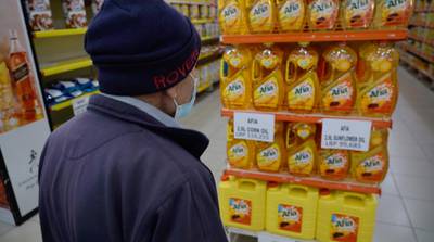 A shopper checks the price of cooking oil at a supremarket in Beirut, Lebanon. Mahmoud Rida