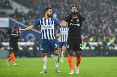 Chelsea's midfielder Callum Hudson-Odoi, right, reacts after missing a chance at the American Express Community Stadium. AFP