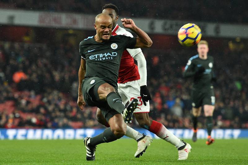 Manchester City's Belgian defender Vincent Kompany clears the ball during the English Premier League football match between Arsenal and Manchester City at the Emirates Stadium in London on March 1, 2018.  / AFP PHOTO / Glyn KIRK / RESTRICTED TO EDITORIAL USE. No use with unauthorized audio, video, data, fixture lists, club/league logos or 'live' services. Online in-match use limited to 75 images, no video emulation. No use in betting, games or single club/league/player publications.  / 