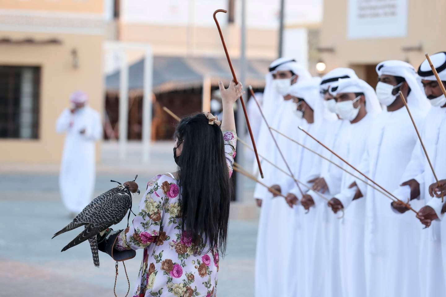 Alia Obaid, 8, joins the men in performing the traditional Emirati dance at Al Dhafra Festival in Abu Dhabi on January 13. Khushnum Bhandari / The National
