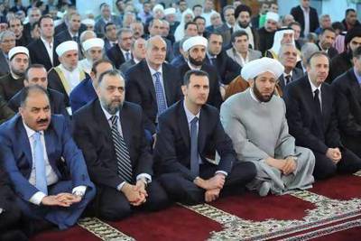 Syria's President Bashar Al Assad (centre) attends Eid Al Fitr prayers at Anas bin Malek mosque in Damascus.