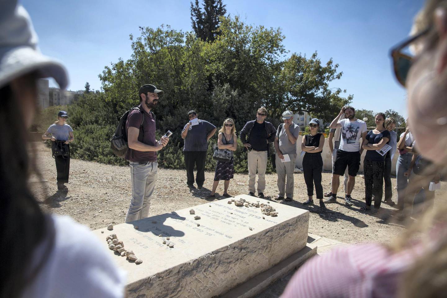Ido Even-Paz , member of "Breaking the Silence" as speaks in English by the grave of American Israeli Jewish settler Baruch Goldstein who killed 29 Palestinians and wounded 125 during the 1994 massacre at the Cave of the Patriachs. He also lead the tour through the divided enclave of Hebron where about 900 Jewish settlers live . (Photo by Heidi Levine for The National).