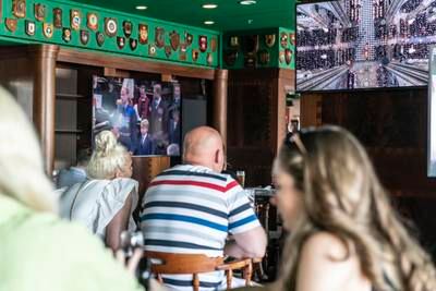 Mourners watch Queen Elizabeth's funeral on television in the Golden Lion pub on board the QE2. Antonie Robertson / The National
