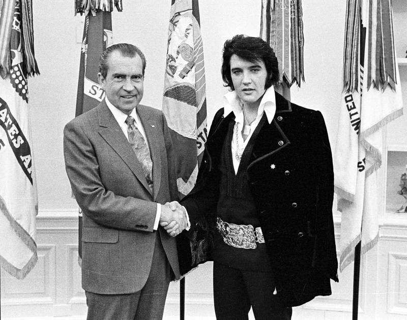 US President Richard Nixon, left, and rock 'n' roll musician Elvis Presley shake hands during a meeting at the White House on December 21, 1970. Getty Images