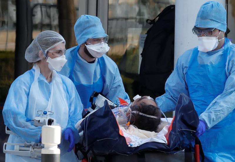 Medical staff move a patient from a special high-speed train to an ambulance during a transfer operation of people infected with coronavirus disease (COVID-19), from Strasbourg to western France hospitals, in Angers, France March 26, 2020. REUTERS/Stephane Mahe