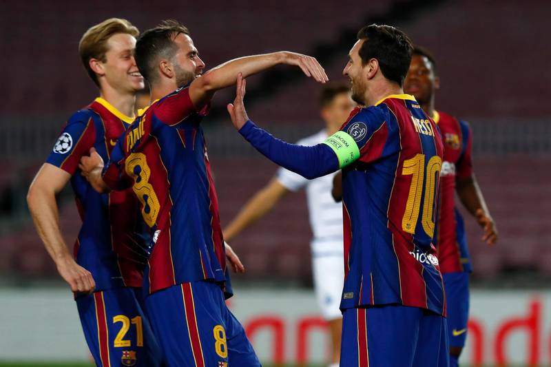 Barcelona's Lionel Messi with teammates after scoring from the penalty spot. AP