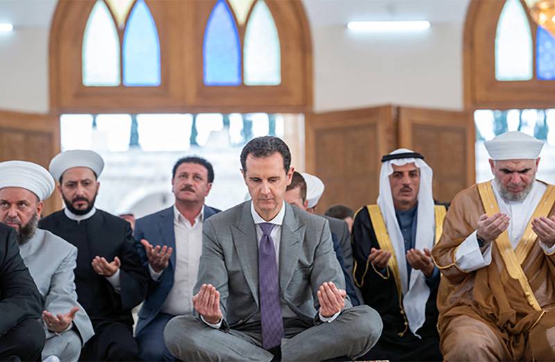 Syria's President Bashar Al Assad, centre, attends Eid Al Adha prayers in Aleppo. AFP