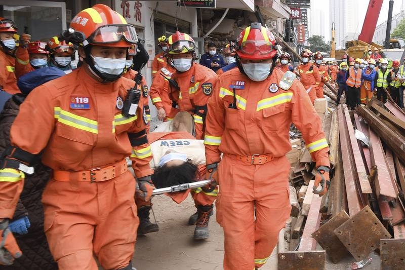 Rescuers evacuate a woman pulled alive from a collapsed building in Changsha, in central China's Hunan Province, on May 1. Another woman was rescued more than 132 hours after it collapsed. Xinhua/AP