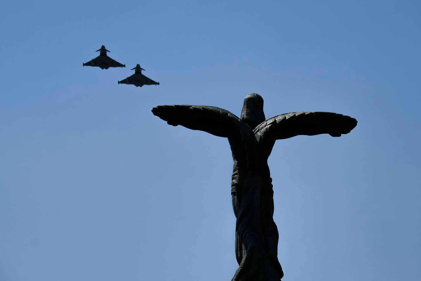 British RAF Typhoon fighter jets fly during a military ceremony at the Aviation Heroes monument in Bucharest, Romania, on Wednesday. AP Photo