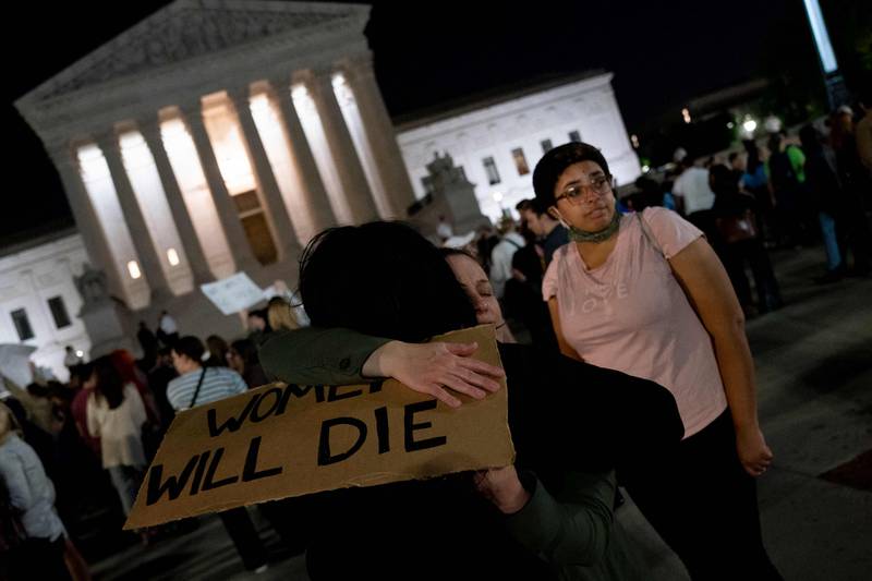 A person holds a sign reading "Women Will Die" as activists gather at the US Supreme Court in Washington, DC. AFP