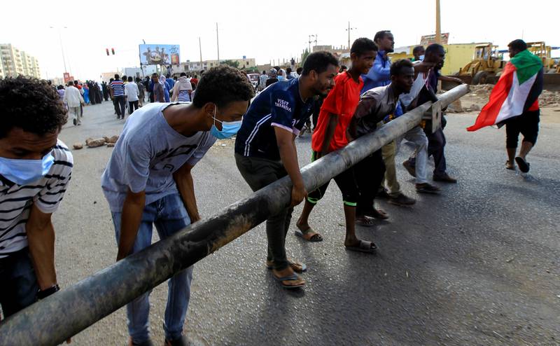 Protesters carry a barricade as they demonstrate against the Sudanese military, in the capital Khartoum. Reuters
