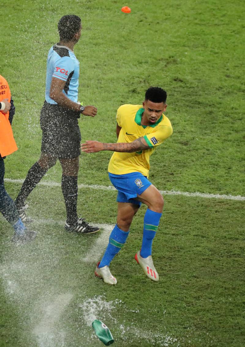 Gabriel Jesus makes his way off the pitch and kicks a water bottle. Reuters