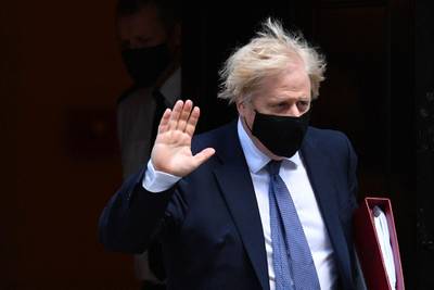 Britain's Prime Minister Boris Johnson, wearing a face mask to combat the spread of Covid-19, leaves 10 Downing Street in central London. AFP