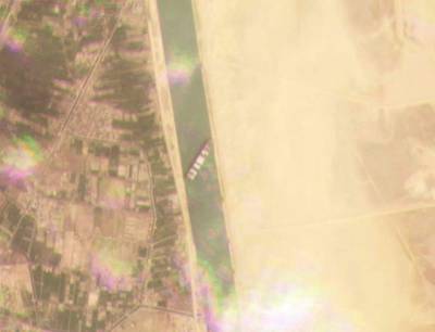 This satellite image from Planet Labs Inc. shows the cargo ship MV Ever Given stuck in the Suez Canal near Suez, Egypt, Tuesday, March 23, 2021. A cargo container ship that's among the largest in the world has turned sideways and blocked all traffic in Egypt's Suez Canal, officials said Wednesday, March 24, 2021, threatening to disrupt a global shipping system already strained by the coronavirus pandemic. (Planet Labs Inc. via AP)
