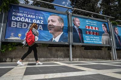 A billboard reads 'one year free natural gas in homes for the kitchen and hot water', with the portrait of Turkish President Recep Tayyip Erdogan reading 'My promise to you' in south-eastern Turkey. AFP