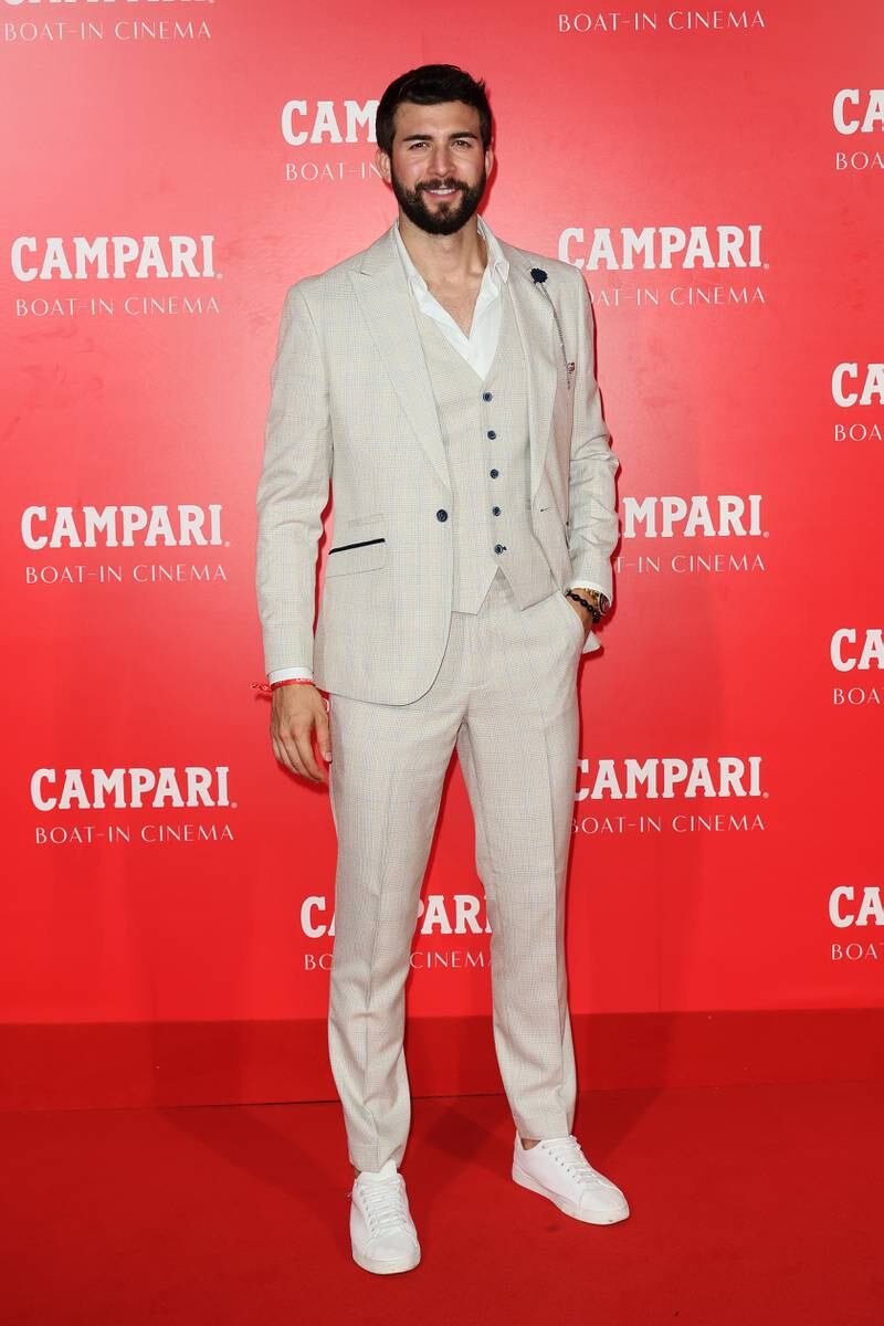 Footballer Alvaro Nunez teams his three-piece suit with trainers for an effortless update. Getty